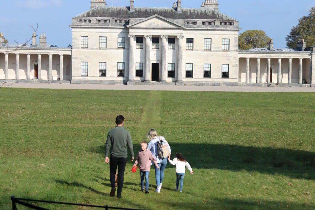 Family with Castlecoole in background